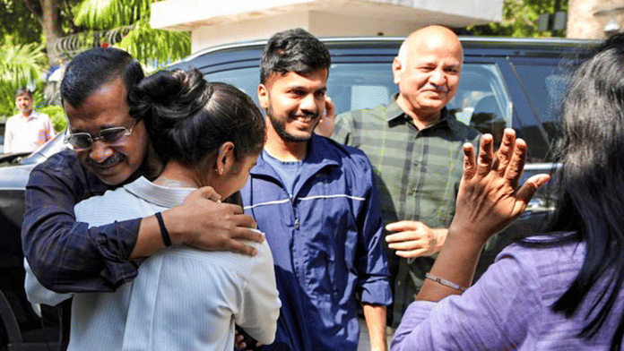 AAP national convener Arvind Kejriwal and party leader Manish Sisodia celebrate with family members after a Delhi court discharged them in an excise policy case, in New Delhi. | AAP via PTI
