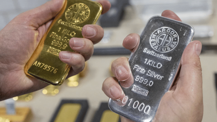 rgor-Heraeus' CEO Robin Kolvenbach holds one kilo bars of silver and gold at the plant of refiner and bar manufacturer Argor-Heraeus in Mendrisio, Switzerland, July 13, 2022 |REUTERS/Denis Balibouse/File Photo