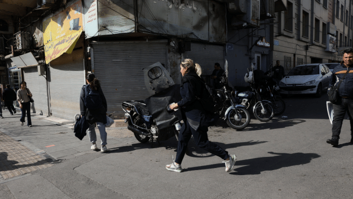 People run for cover following an explosion, after Israel said it launched a pre-emptive attack against Iran, in Tehran. Majid Asgaripour/WANA via Reuters
