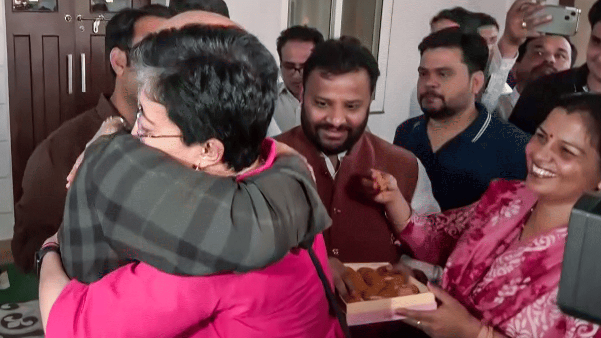 AAP leader Manish Sisodia shares a hug with Delhi Assembly LoP Atishi after he was cleared in Delhi excise policy case. | ANI video grab 