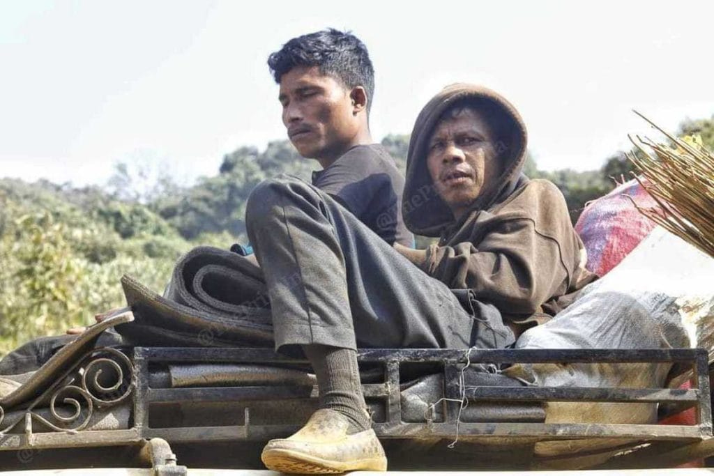 Coal labourers ride in the back of a truck in East Jaintia Hills