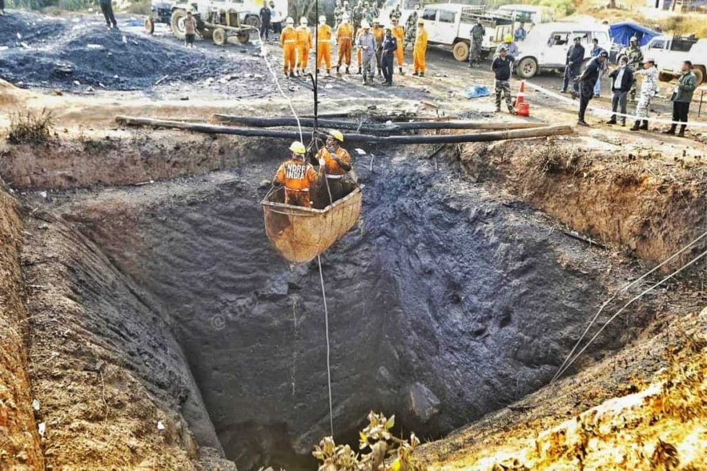 National Disaster Response Force personnel descend into a rat-hole pit in Thangsko, East Jaintia Hills, after the 5 February blast that killed 31 miners