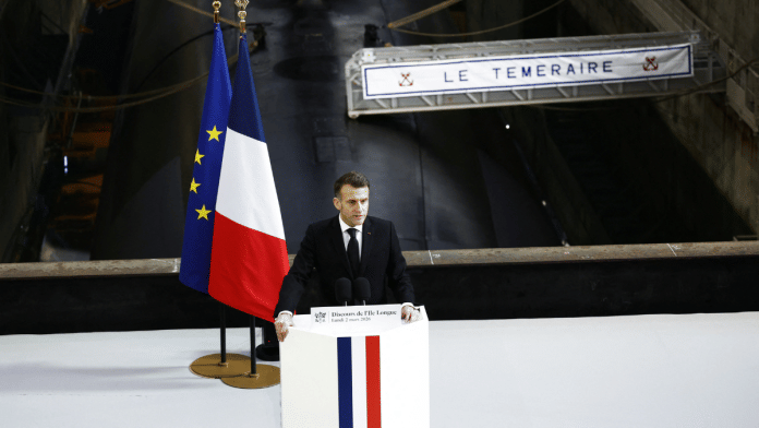 French President Emmanuel Macron delivers a speech next to the submarine 'Le Temeraire' (The Temerarious) at the nuclear submarines Navy base Ile Longue in Crozon, France | Yoan Valat/Pool via Reuters