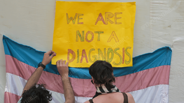 Trans activists putting up a poster at Jantar Mantar, New Delhi | Photo: Suraj Singh Bisht, ThePrint