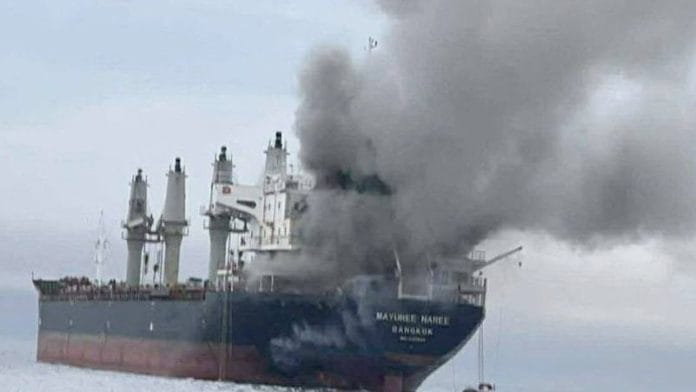 The Thailand-flagged cargo ship Mayuree Naree engulfed in black smoke in the Strait of Hormuz, March 11, 2026. | ROYAL THAI NAVY/Handout via REUTERS