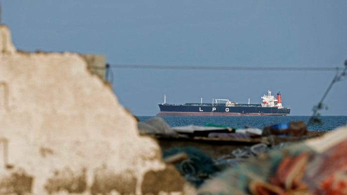 FILE PHOTO: A LPG gas tanker sits anchored as the traffic is down in the Strait of Hormuz, amid the U.S.-Israeli conflict with Iran, in Shinas, Oman, March 11, 2026. | REUTERS/Benoit Tessier/File Photo
