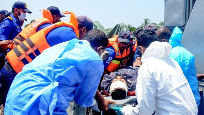 Medical personnel and Sri Lanka Navy sailors provide emergency treatment to an injured Iranian crew member rescued after responding to a distress call from the Iranian military ship, IRIS Dena, while at sea within Sri Lanka’s maritime search and rescue region, in Indian Ocean, Sri Lanka, March 4, 2026. | Sri Lanka Navy/Handout via REUTERS