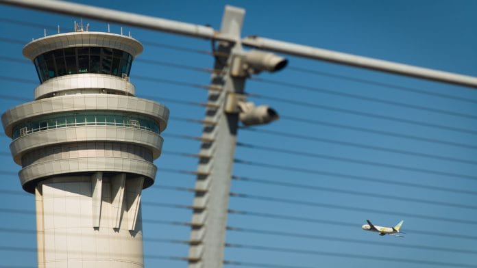 An aircraft passes a control tower during takeoff. | Bloomberg