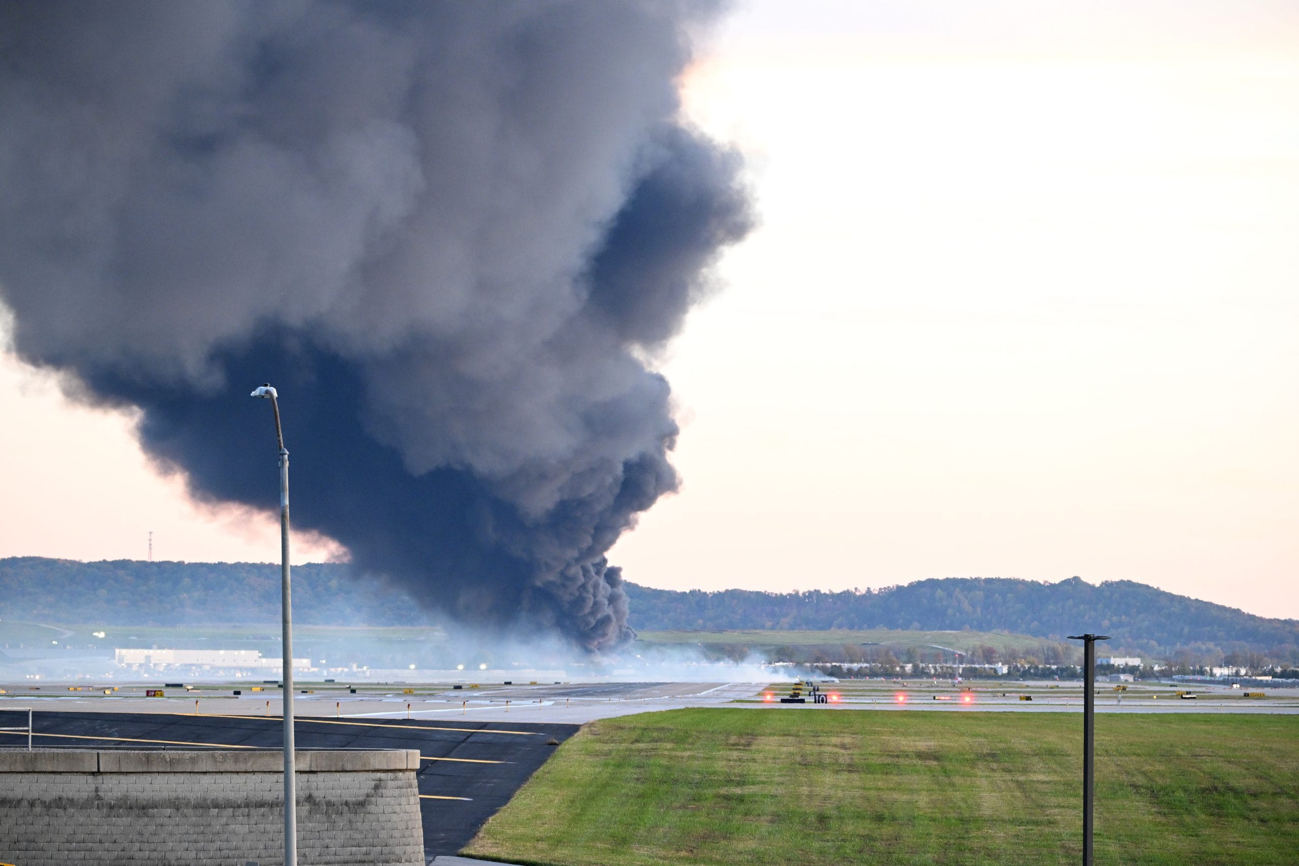 Fire and smoke mark where a UPS cargo plane crashed near Louisville Muhammad Ali International Airport in Kentucky in November 2025. | Bloomberg