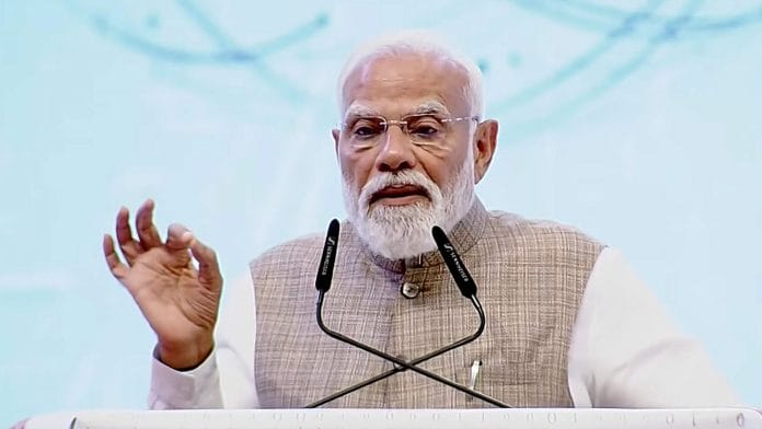 In this screengrab from a video posted on March 12, 2026, Prime Minister Narendra Modi addresses the NXT Summit 2026 at Bharat Mandapam, in New Delhi. | @NarendraModi/YT via PTI Photo