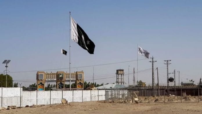 General view of the Pakistan's flag and the Taliban's flag in the background as seen from the Friendship Gate crossing point in the Pakistan-Afghanistan border town of Chaman, Pakistan (Image/Reuters)