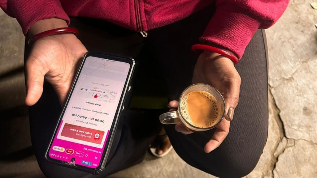 Every morning, gig workers gather and keep an eye on the phone for their job bookings. Manisha Mondal | ThePrint