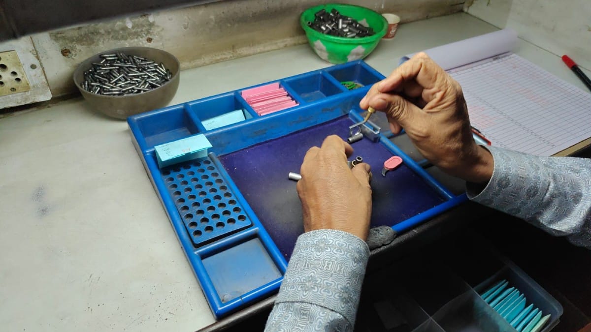 A worker inspects his tools inside a workshop | Esha Mishra/ThePrint