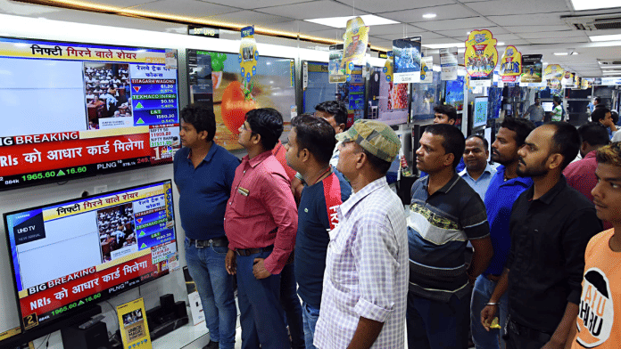 People watching news at a showroom in Patna | ANI File