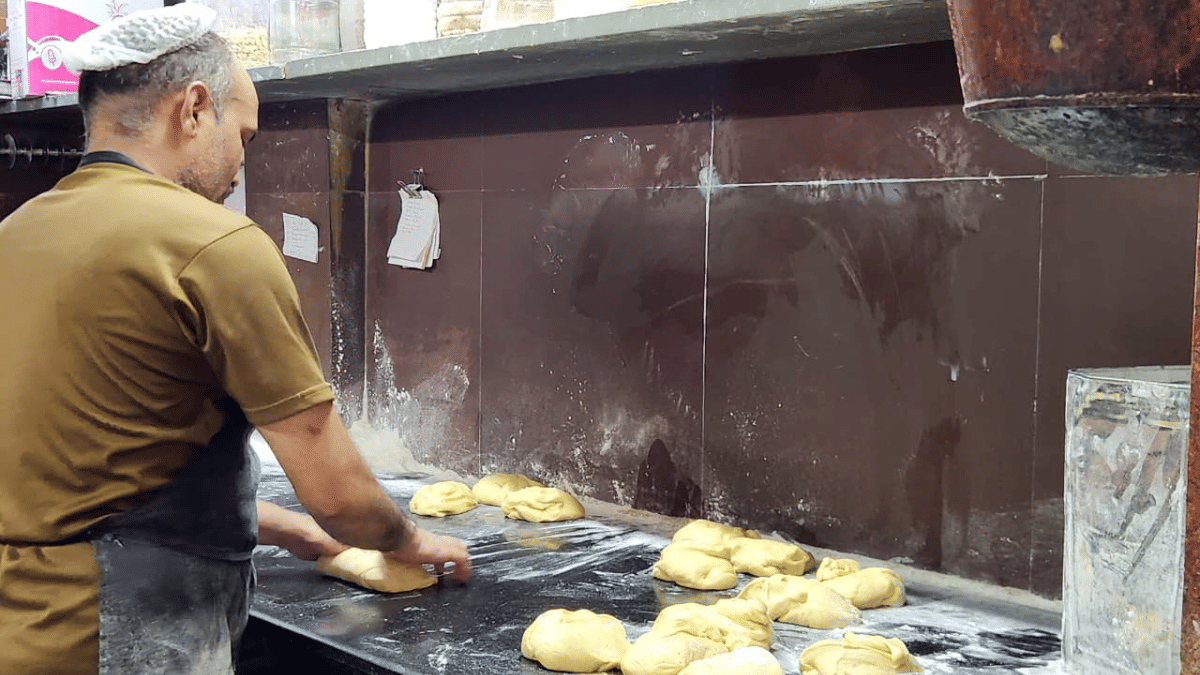 A worker kneads dough before shaping up breads at Parsi bakery | Purva Chitnis | ThePrint