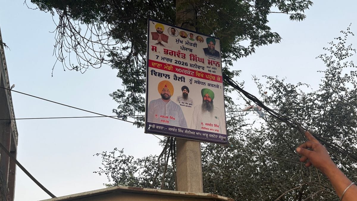 A resident of Amarkot village pointing to a poster of sarpanch Jarmal Singh | Photo: Sakshi Mehra, ThePrint