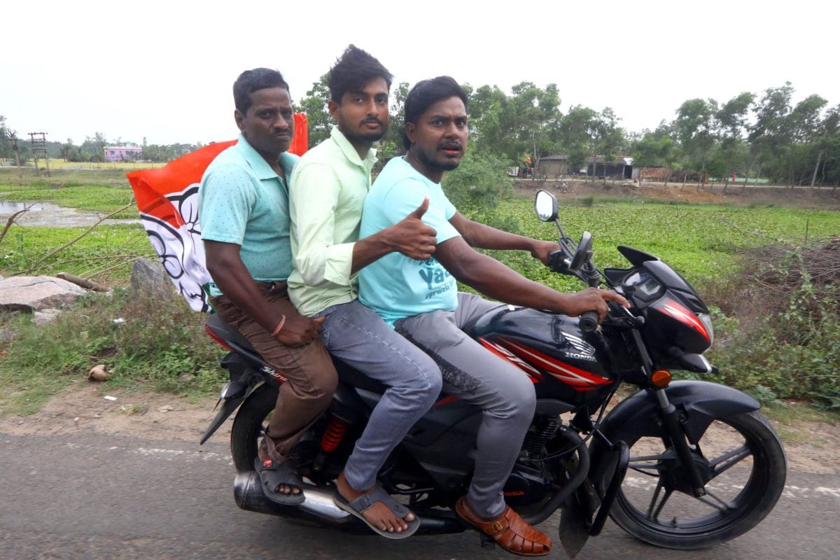 TMC supporters in motor bike holding party flag going towards the election rally | Praveen Jain | ThePrint