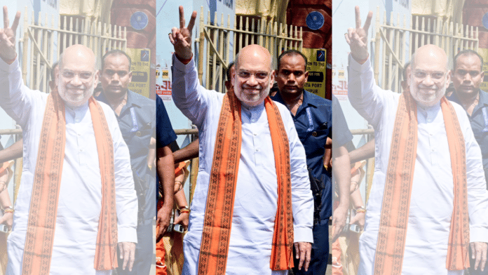 Union Home Minister Amit Shah shows a victory sign after the nomination submission of BJP candidate for Bhabanipur and Nandigram Assembly constituencies, Suvendu Adhikari, unseen, ahead of the West Bengal Assembly elections, in Kolkata, Thursday, April 2, 2026. (PTI Photo)