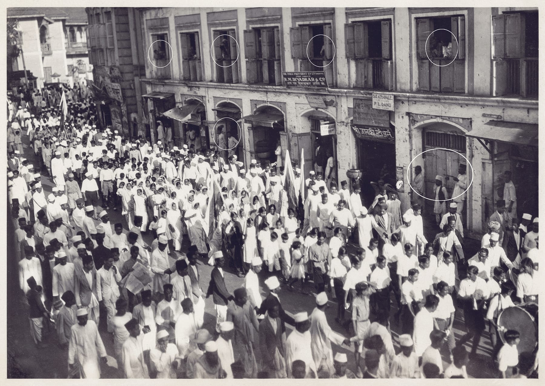 “A boycott procession in the market area.” c. 1930–1931 Gelatin Silver Print, 115 x 160 mmACP: 98.77.0002 (90b). The circled sections in the photograph reveal shadowy figures on the edges of the rally, spectators on the verge of being swept into the political spa