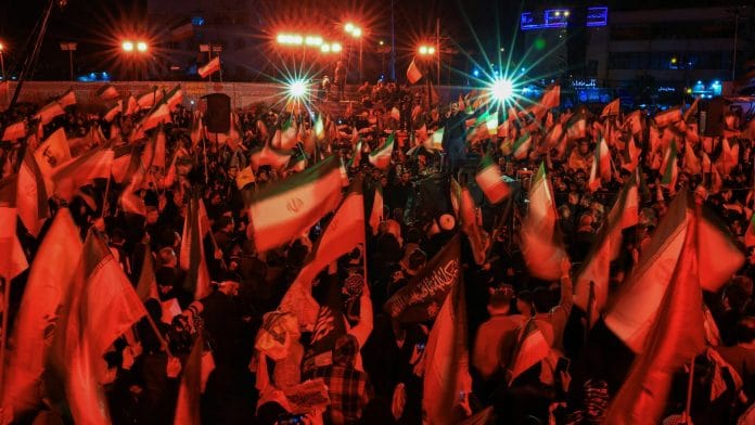 People chant slogans during an anti-U.S. and anti-Israel rally at Enghelab Square, amid a two-week ceasefire in the U.S.-Israeli war on Iran, in Tehran, Iran, April 13, 2026. | REUTERS/Thaier Al Sudani