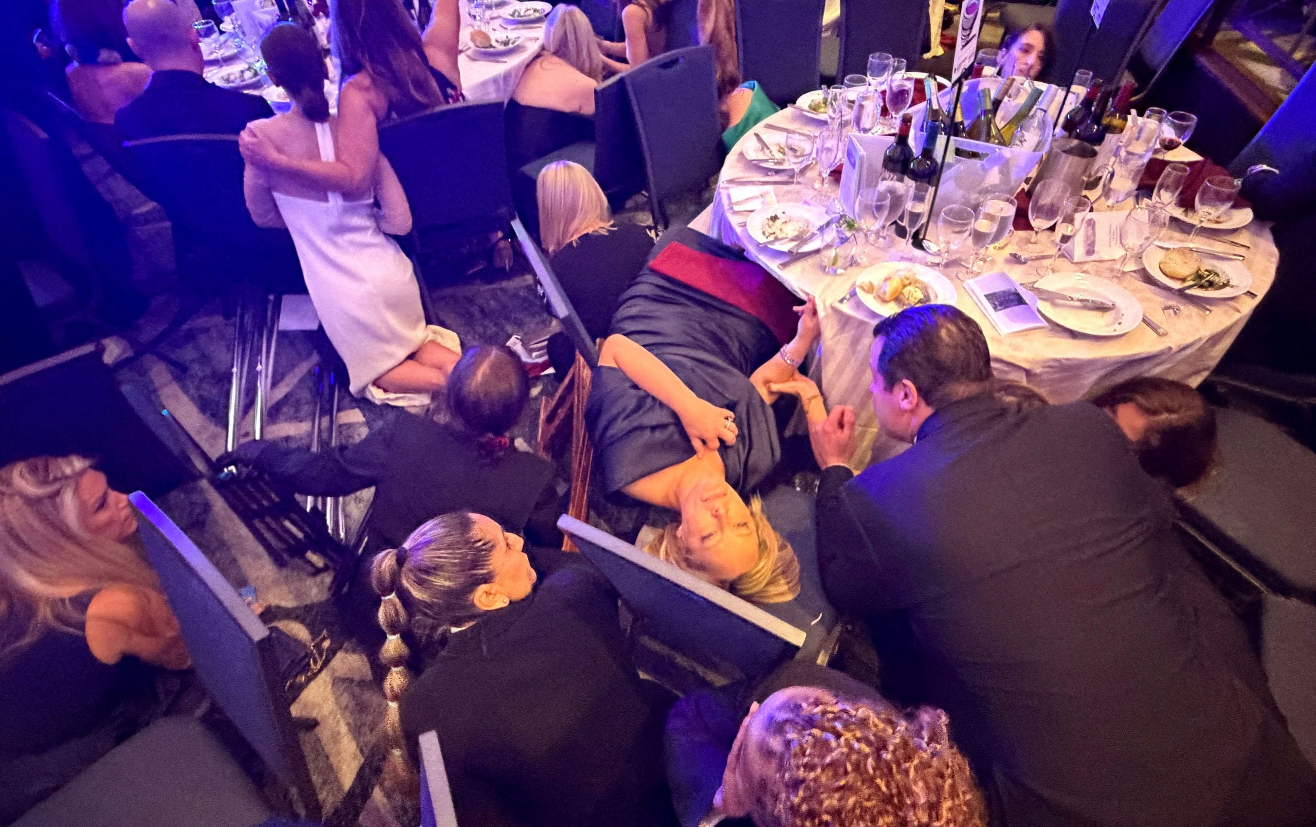Guests take cover after U.S. President Donald Trump and first lady Melania Trump were rushed out of the White House Correspondents' Association dinner by Secret Service agents after a loud, unidentified noise, in Washington, D.C., U.S. April 25, 2026 | Reuters 