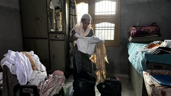 Gurjeet Singh Khalsa’s wife, Gurpreet Kaur, goes through his belongings brought down from the tower | Photo: Anushka Srivastava