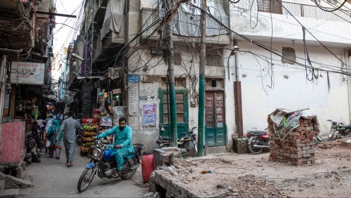 Power lines hang above a street in Lahore. | Bloomberg