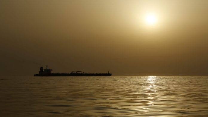 An oil tanker in the Mediterranean sea is silhouetted against the hazy sky in the waters off the coast of Gibraltar. Photographer: Bloomberg Creative Photos/Bloomberg