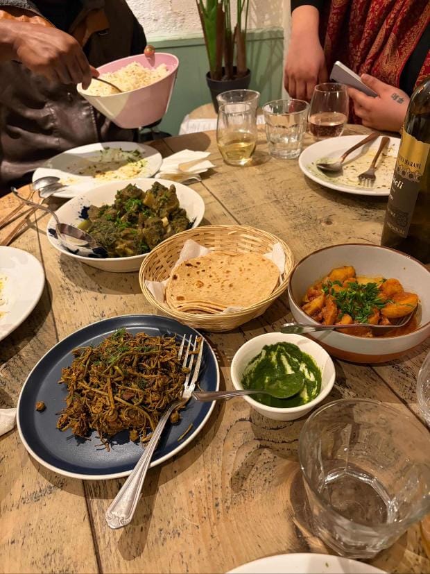 Green cardamom lamb (phote mein gosht), seyal bhee (lotus stem), ker kumat sangri on the table at Sapna Ajwani’s supper club, Sindhi Gusto. | Ajwad Hussain