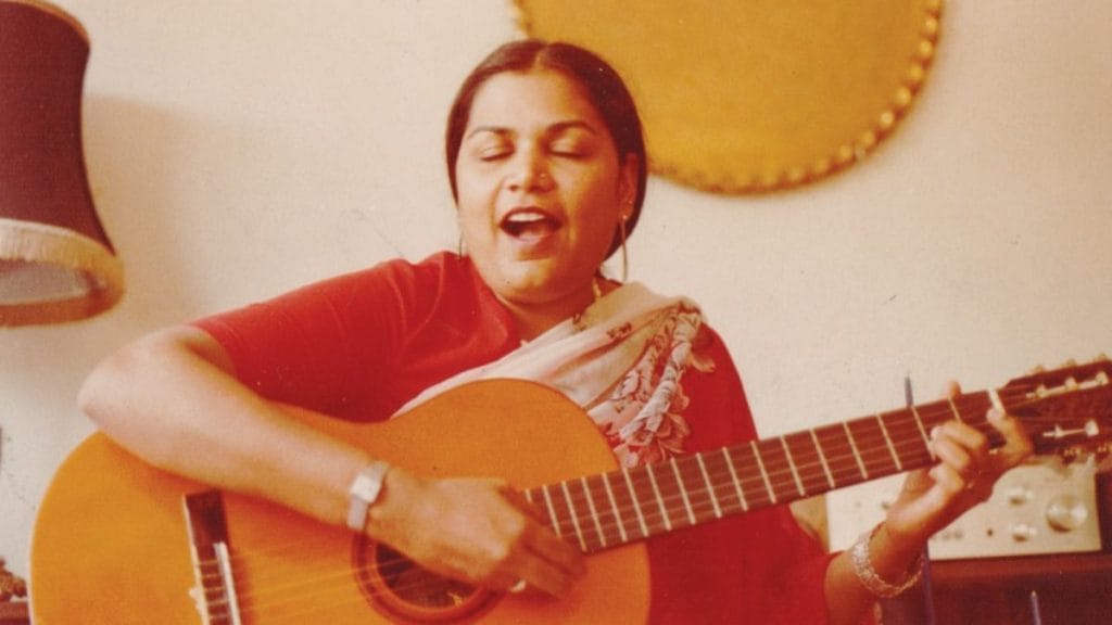 A young Usha Uthup strumming the guitar. Image: @singerushauthup/Facebook