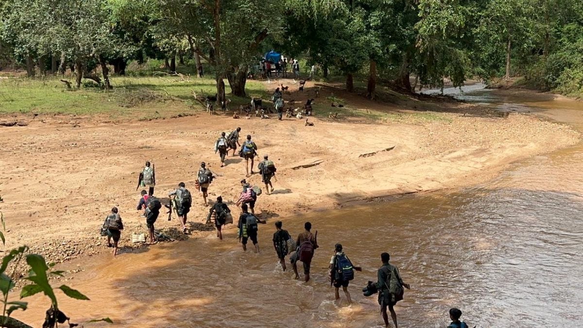 Undated photo of Maoist cadres crossing a river to surrender before security forces | By special arrangement