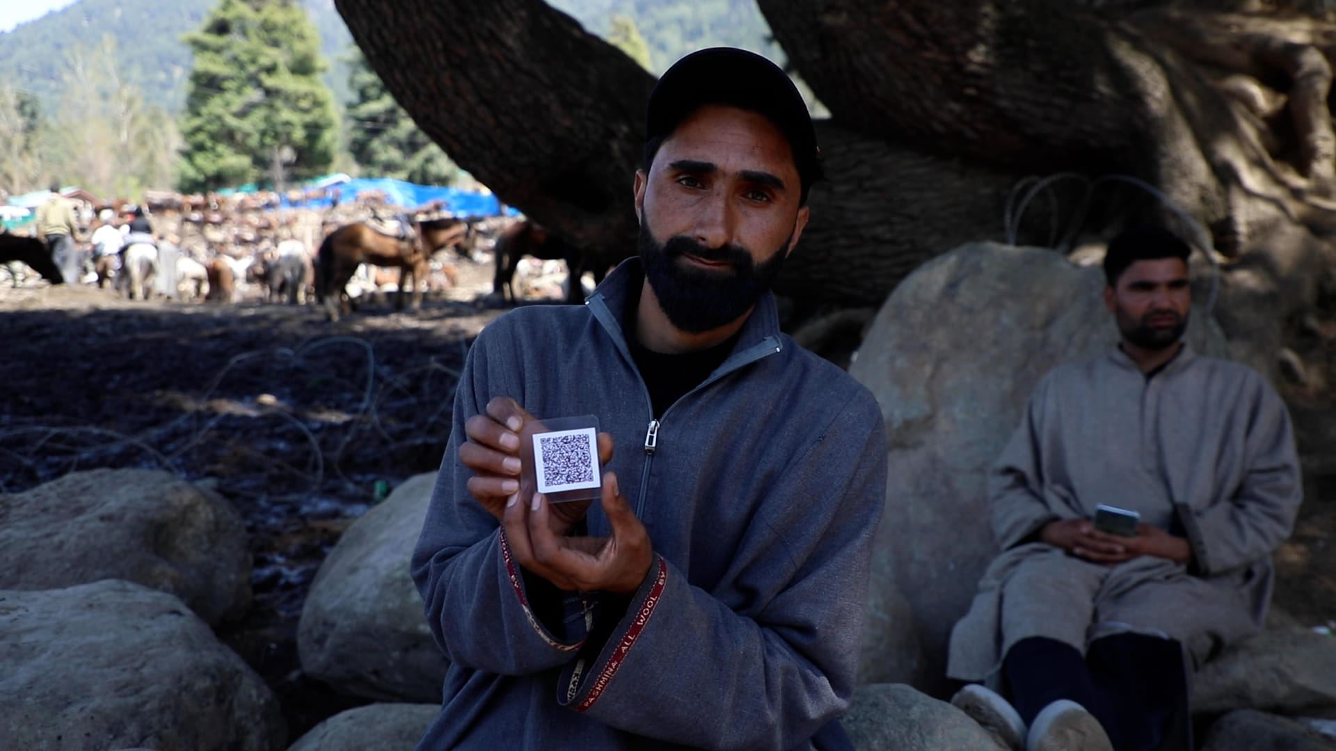 Ponywallah Umar Bashir Wani shows his QR-coded ID card. Ponywallahs like him are yearning for the opening of all tourist spots in Pahalgam. | Mohammad Hammad/ThePrint