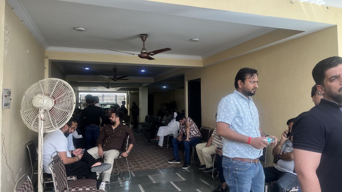 Friends and relatives gather in the parking area of A-144, Preet Vihar, to offer condolences after the killing | Nootan Sharma, ThePrint