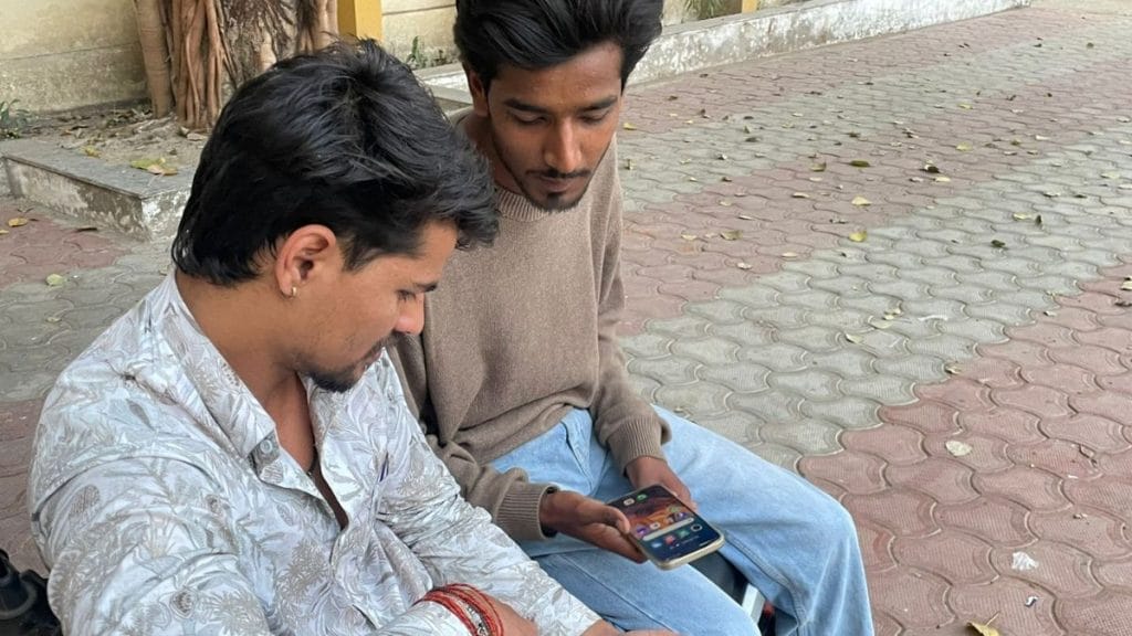 Two young men in the town of Raisen in Madhya Pradesh look at the dance reels and freestyle dance videos they plan to upload on their Instagram. Sabah Gurmat | ThePrint