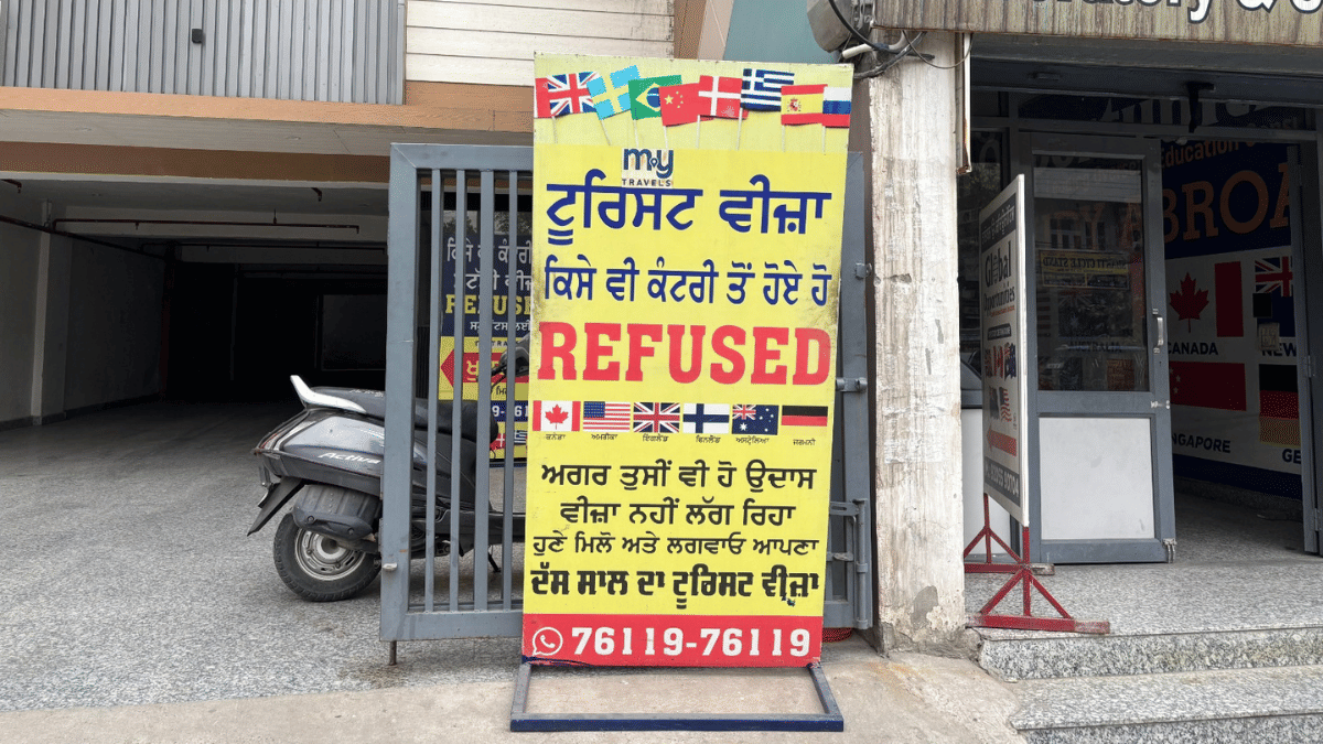 A placard set up by immigration agents in Jalandhar promising visa to those candidates who faced refusal earlier | Samridhi Tewari | ThePrint