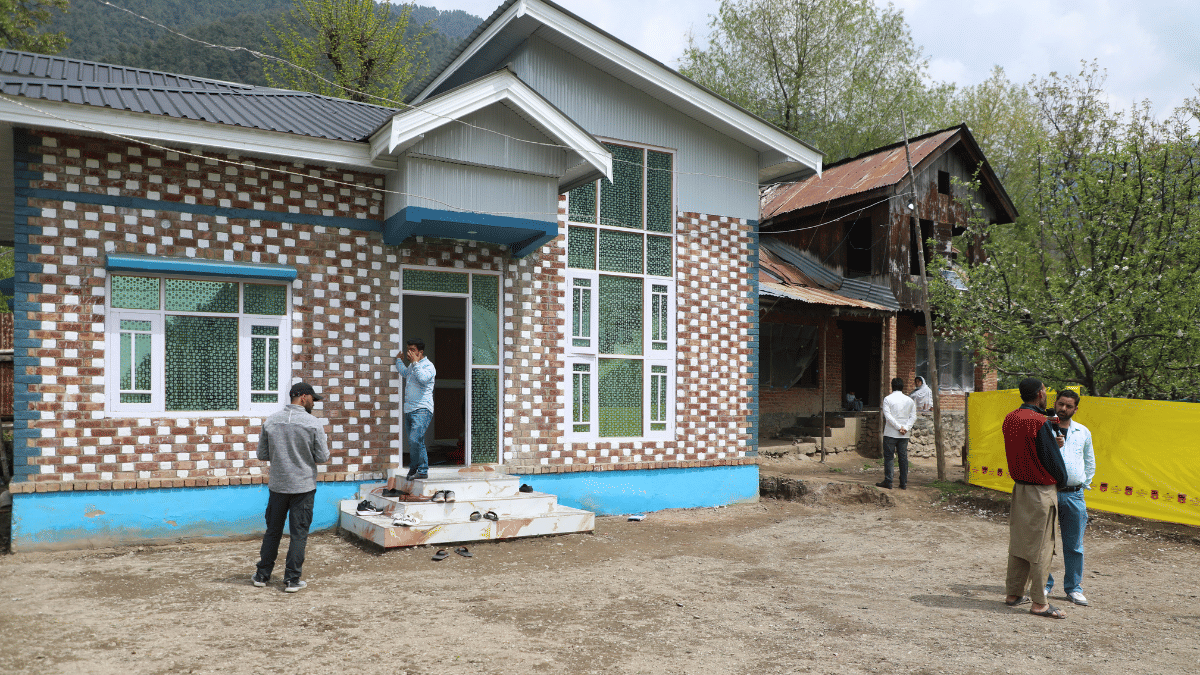 The new house that has come up for the Shahs at Haptnar village in Anantnag. The family's old house is seen at the background | Mohammad Hammad | ThePrint