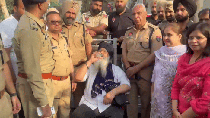 Gurjeet Singh Khalsa is surrounded by Punjab Police and his family after his descent from telecom tower | By Special Arrangement .