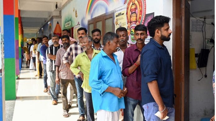 Voters wait in a queue to cast their votes during the second phase of the Lok Sabha Polls, at a polling station in Thiruvananthapuram, Friday. | ANI