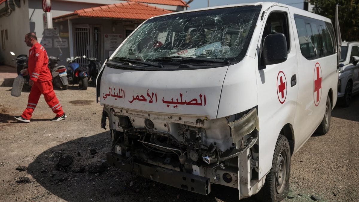 A staff member walks past a damaged Lebanese Red Cross vehicle after a drone strike in Tyre, Lebanon, 13 April 13 | Photo: Reuters