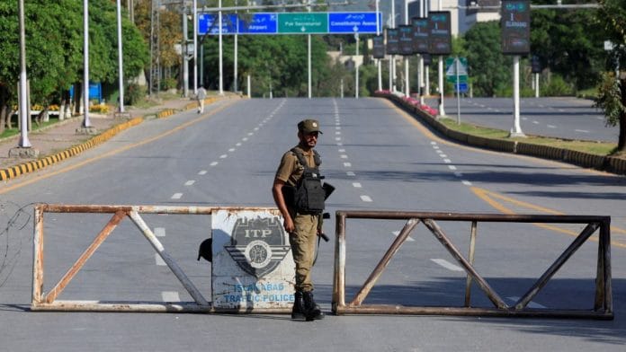 A Pakistani Army soldier stands guard on a road leading to Serena hotel in Islamabad | Photo: Akhtar Soomro | Reuters