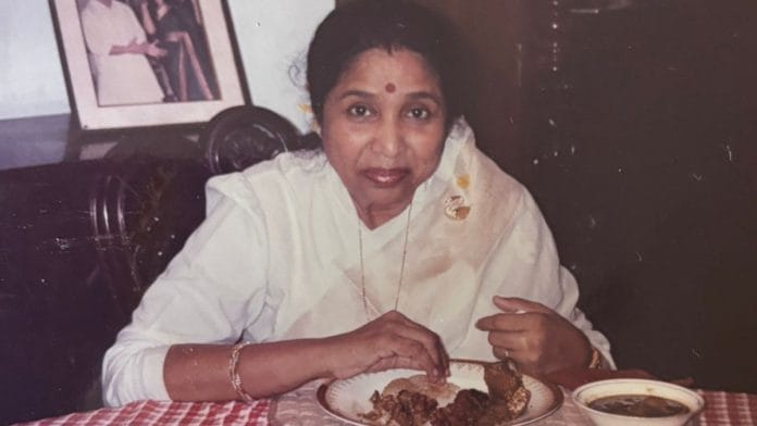 Asha Bhosle in Shobha De's home. On her plate are kebabs she's prepared. | Shobhaa De