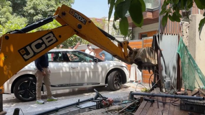 Officials oversee the demolition of alleged encroachments outside a villa in Gurugram during a citywide crackdown following an interim order by the Punjab and Haryana High Court. | Anushka Srivastava | ThePrint