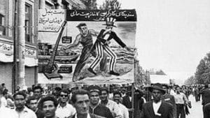 A banner showing America being kicked out of Iran during a 1950s political protest in Tehran |Wikimedia commons