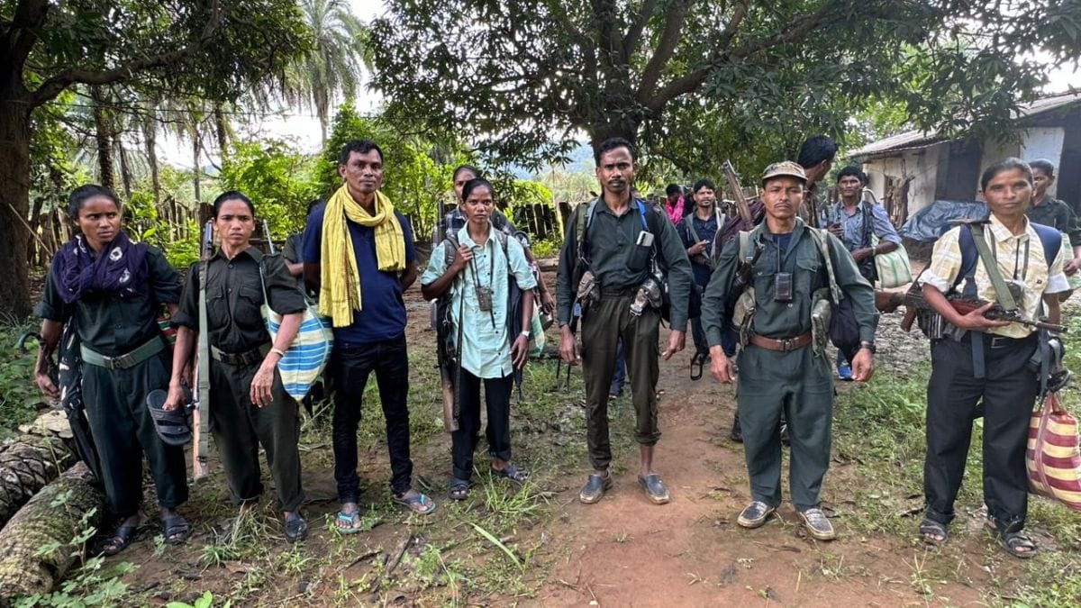 Kanker-based journalist Manku Netam (in blue t-shirt) Maoist cadres before their surrender in Jagdalpur last October | By special arrangement