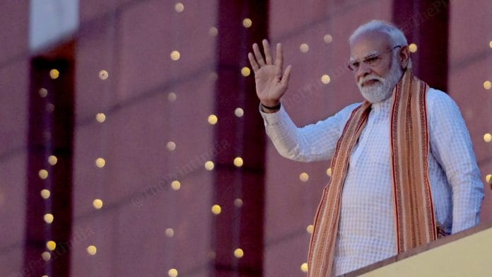 Prime Minister Narendra Modi waves to the crowd at BJP headquarter, in New Delhi | Suraj Singh Bisht | ThePrint