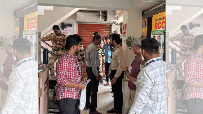 Security personnel and civic officials gathered at the sealed premises of RCC Coaching Classes following action by the Pune Municipal Corporation in connection with the NEET-UG 2026 paper leak case, in Pune on Wednesday. The institute is owned by Shivraj Motegaonkar, who was arrested by the CBI last week. | PMC/ANI Photo