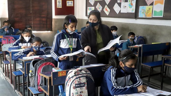 Students attend a session in a classroom as the Delhi government allows reopening of primary and secondary classes after a prolonged closure, in view of the COVID-19 pandemic, at Vidya Bal Bhawan Senior Secondary School, in New Delhi on Monday. | ANI Photo