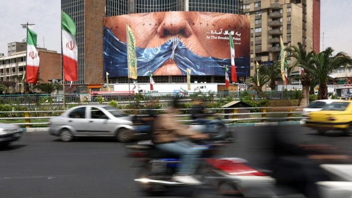 People drive past an anti-U.S. billboard depicting U.S. President Donald Trump and the Strait of Hormuz, in Tehran, Iran, May 2, 2026. Majid Asgaripour/WANA (West Asia News Agency) via REUTERS