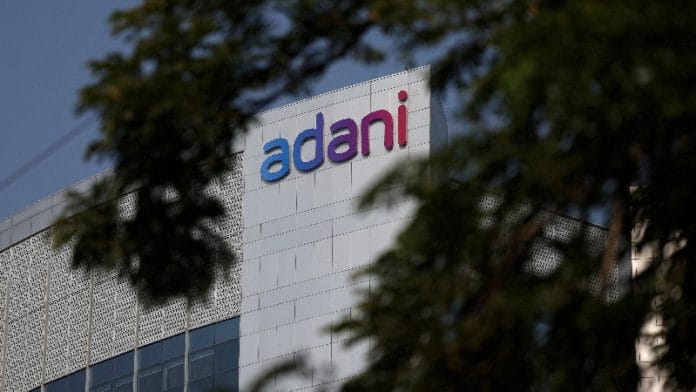 FILE PHOTO: The logo of the Adani Group is seen on the facade of its Corporate House on the outskirts of Ahmedabad, India, November 21, 2024. | REUTERS/Amit Dave/File Photo/File Photo