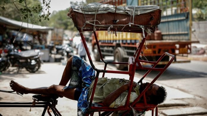 A man sleeps in his rickshaw during a heatwave on a hot summer day in New Delhi, India, June 18, 2024. The India Meteorological Department (IMD) classified nine heat wave days in Delhi this June, up sharply from the historic norm of one during the month. Scientists say the heat is being worsened by human-driven climate change. | Reuters